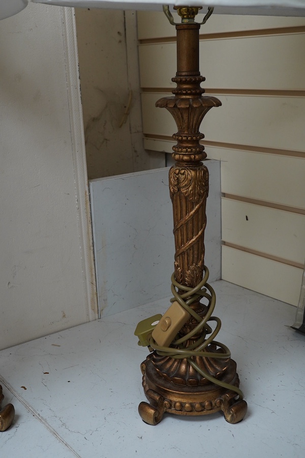 A pair of gilt resin table lamps with white shades, 76cm high. Condition - fair to good.